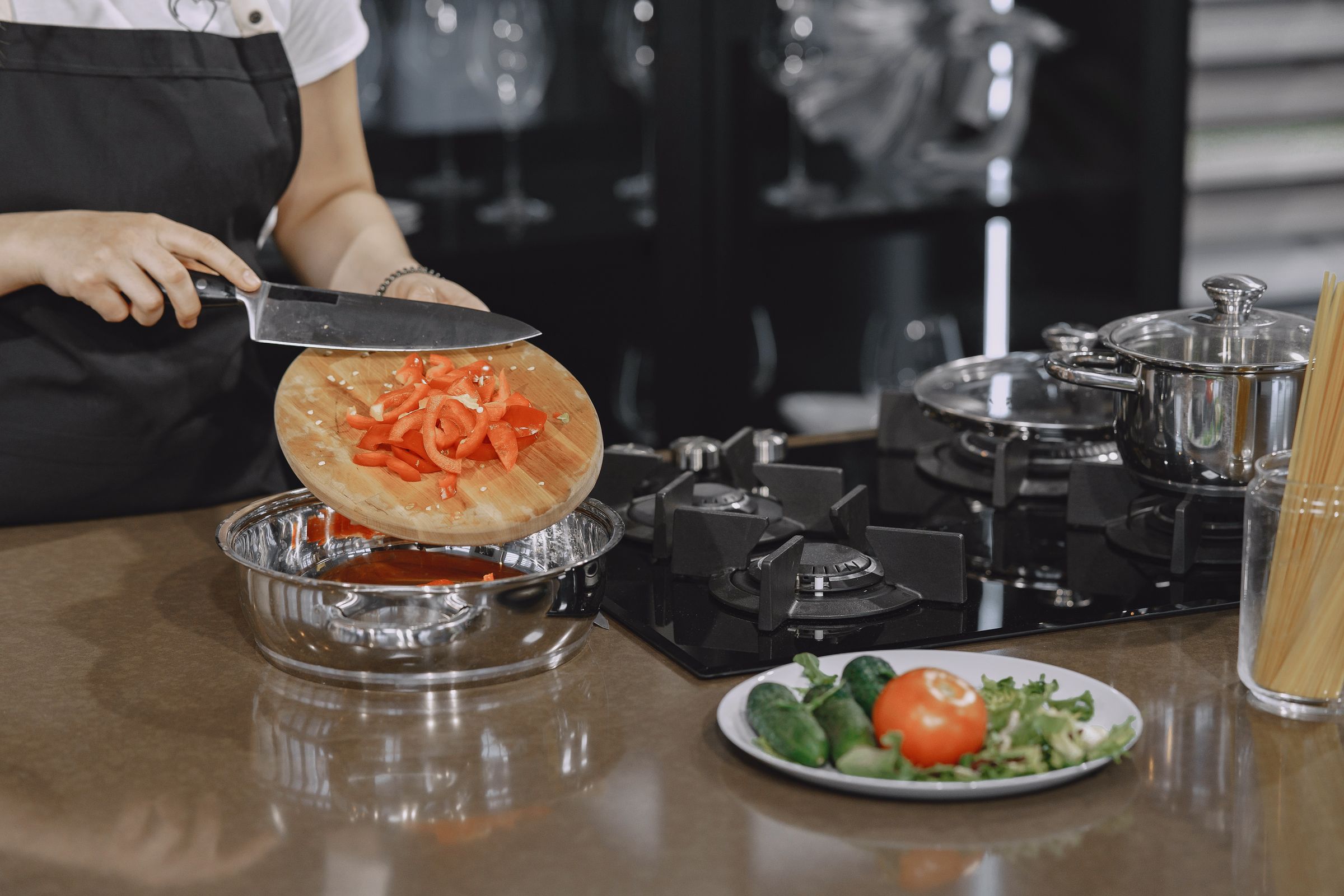Hands preparing fresh vegetables on a wooden chopping board for a blood pressure diet