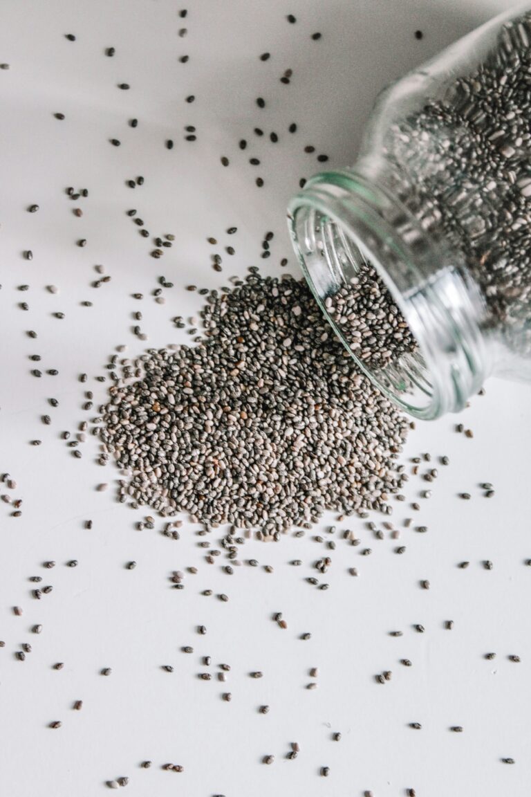 A clear glass jar filled with dry chia seeds