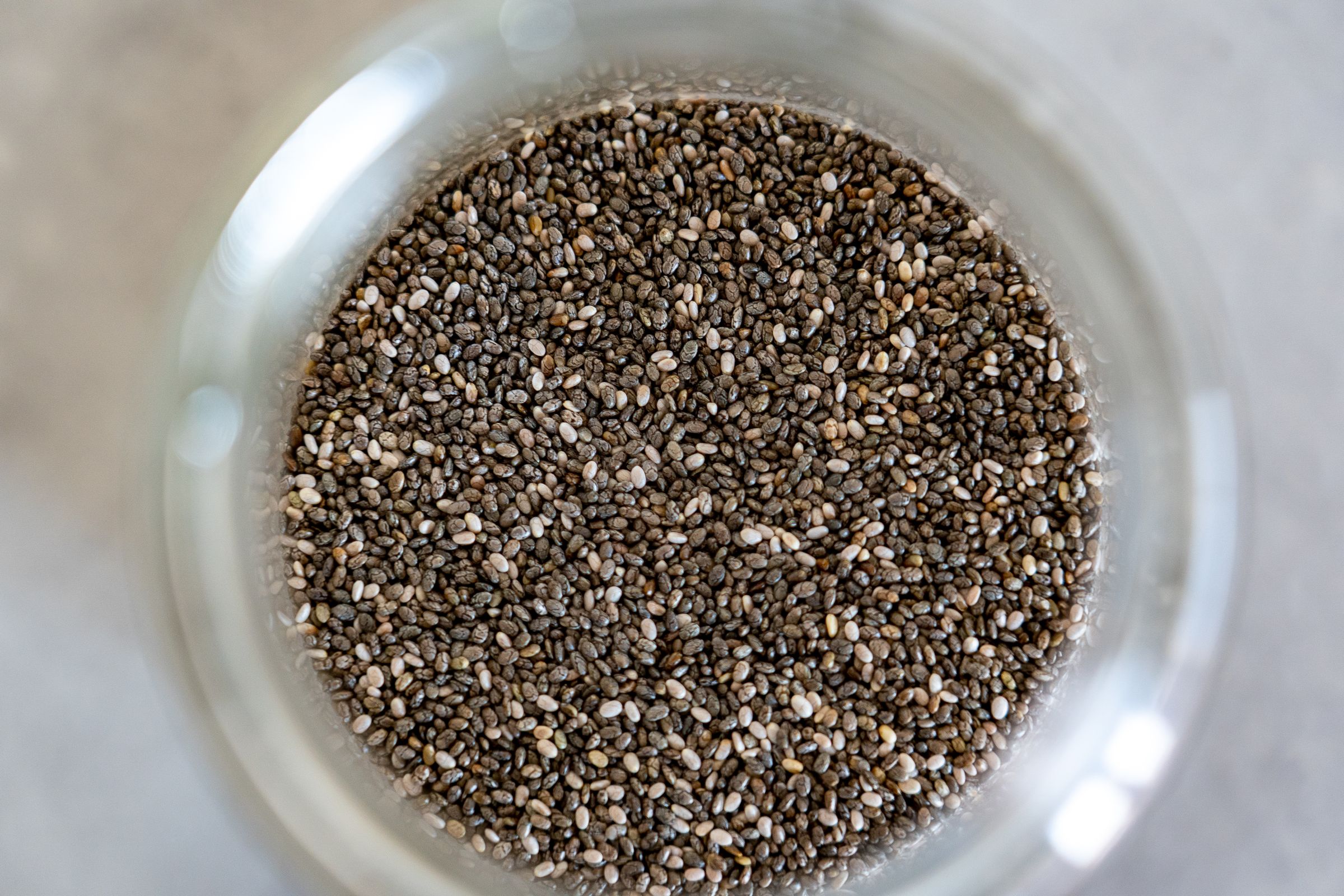 A glass jar filled with swollen soaked chia seeds
