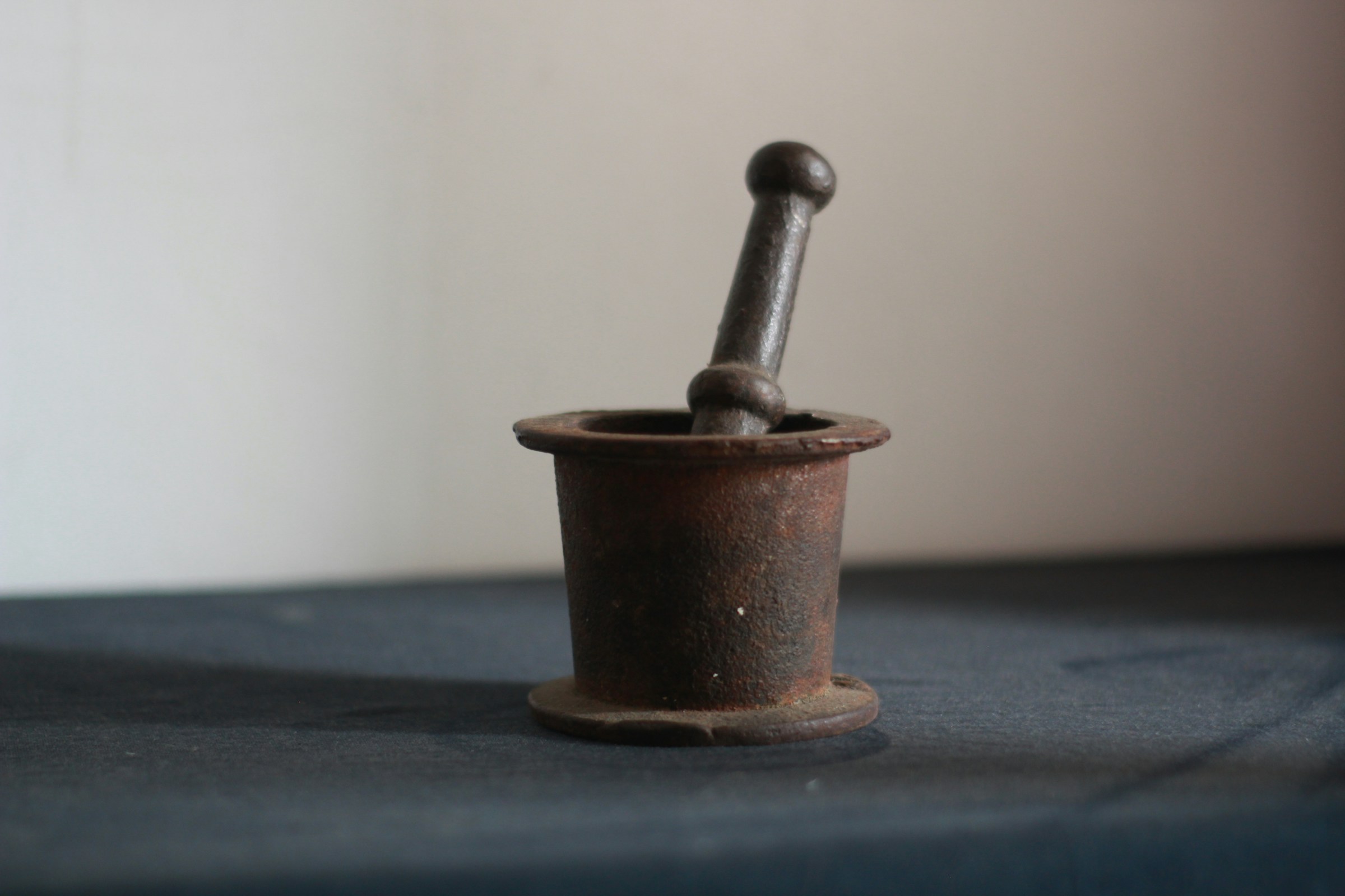 Shilajit preparation: a black mortar and pestle used for traditional medicinal preparation